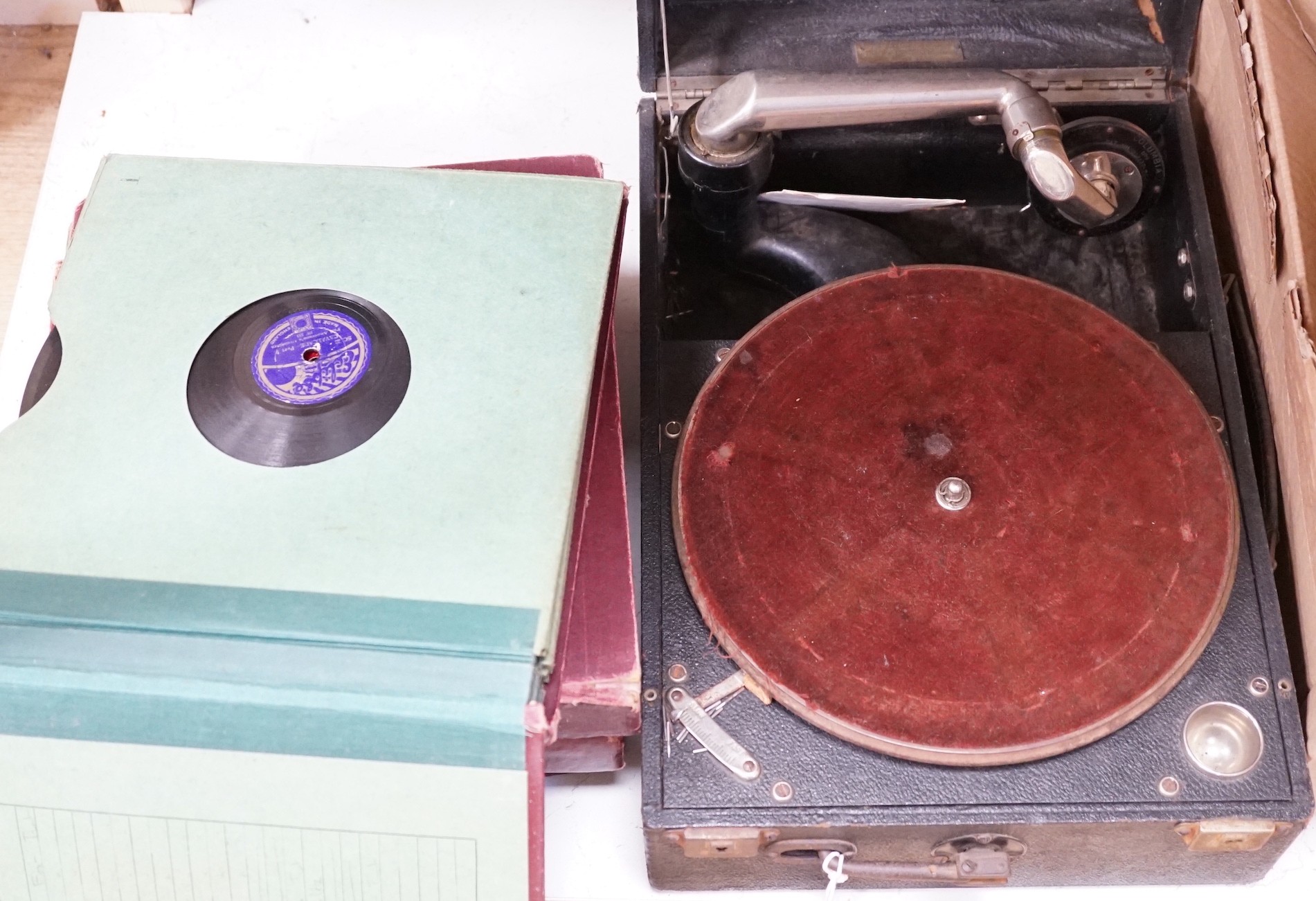 An HMV tabletop wind up gramophone and records